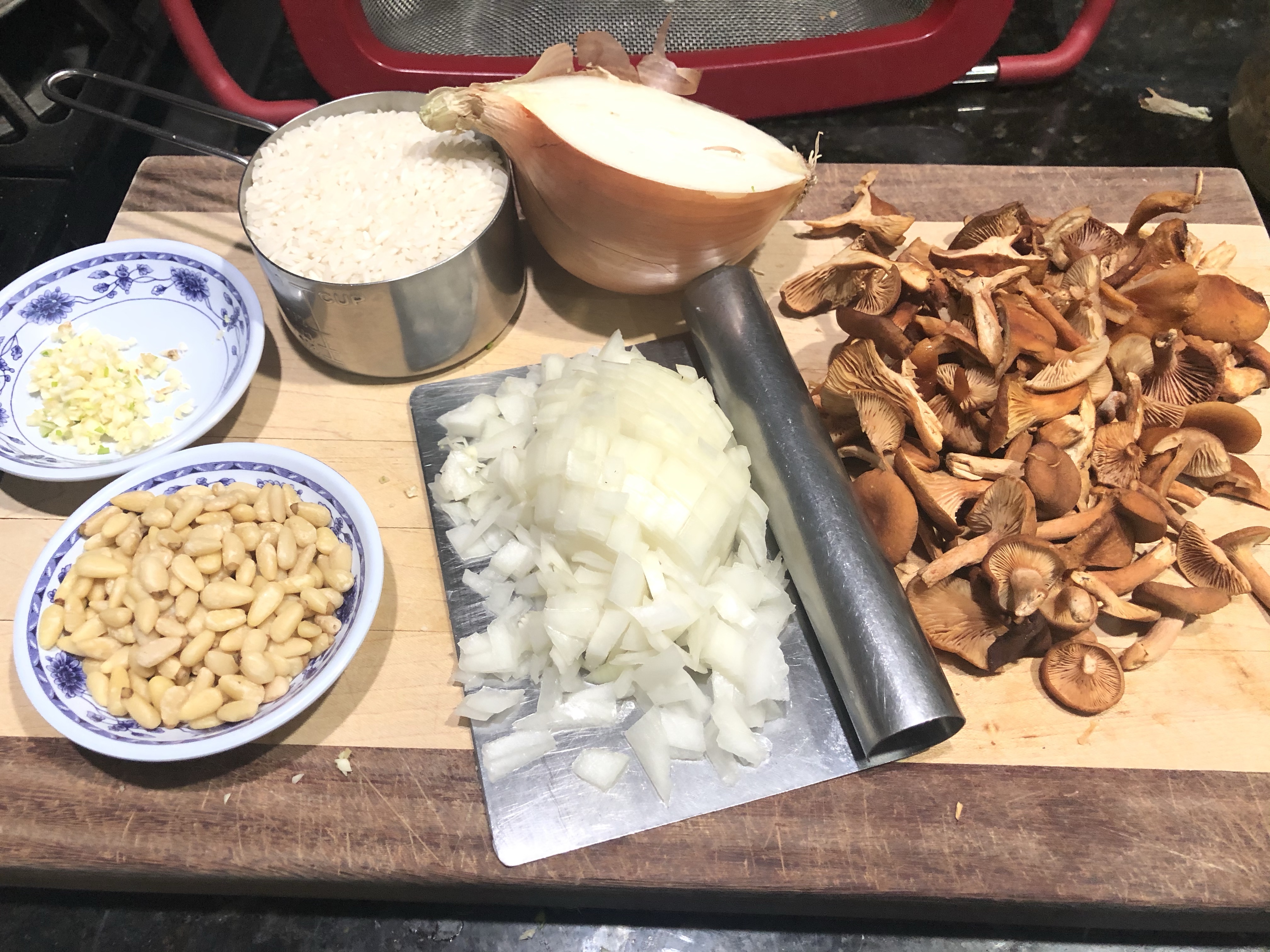 Ingredients prepared and ready to cook: white rice, garlic, onions, pine nuts, candy cap mushrooms