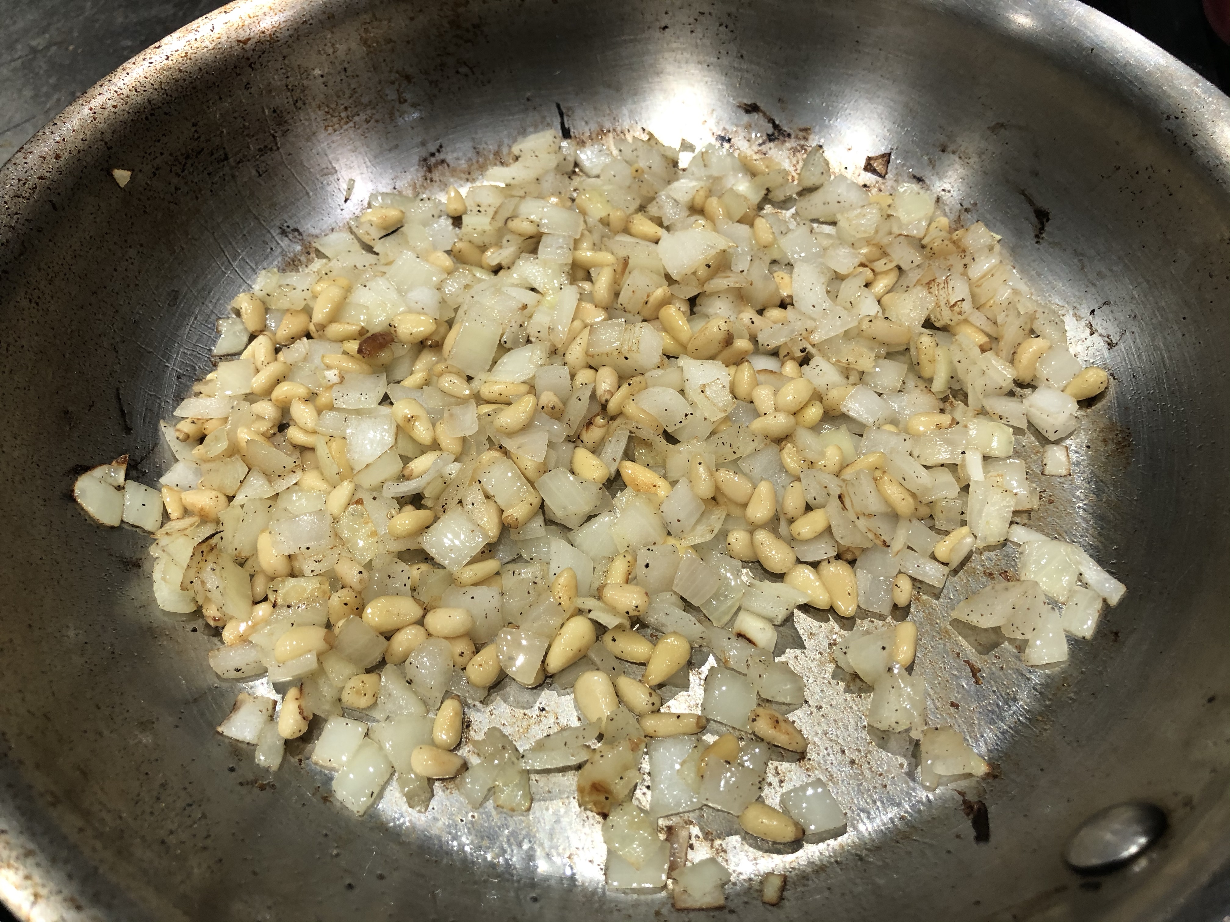 Cleared onions and toasted pine nuts ready for garlic and candy cap mushrooms.