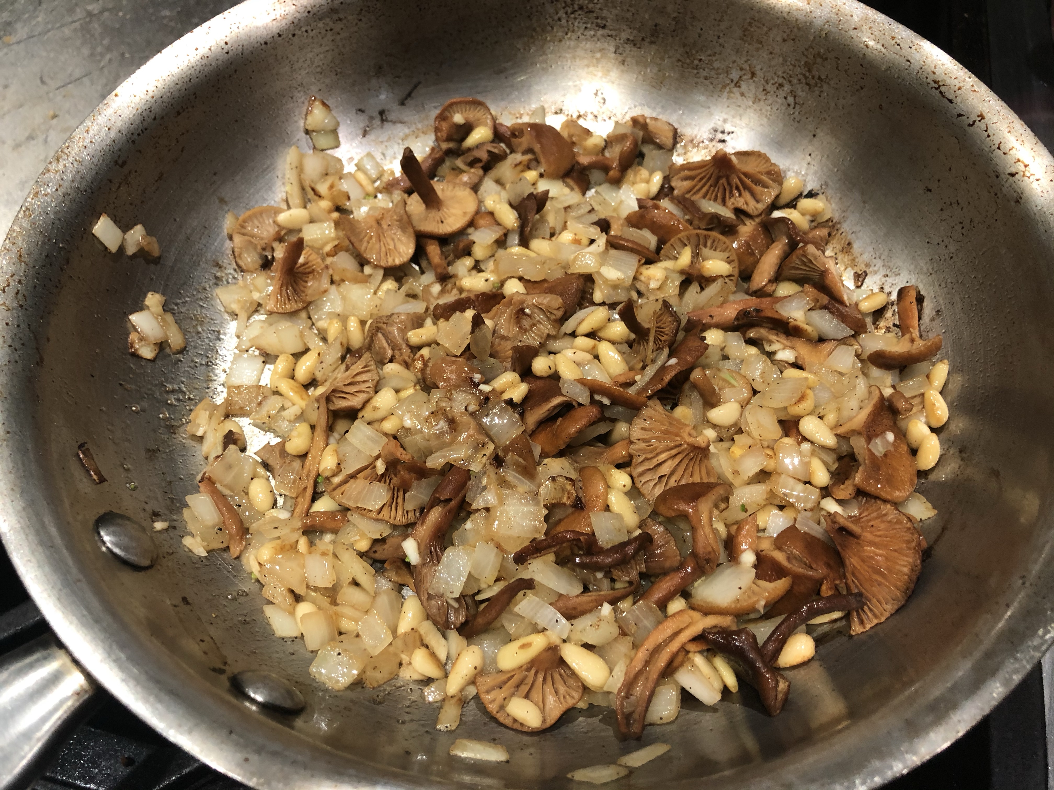 Mushrooms sautéd with onions, garlic, and pine nuts. Ready to add rice.